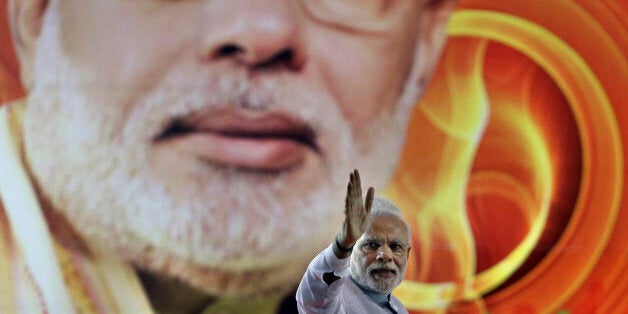 India's Prime Minister Narendra Modi waves to his supporters after addressing a rally organized by his party, the ruling Bharatiya Janata Party (BJP), in Bangalore, India, Friday, April 3, 2015. Modi's speech was mostly addressed to farmers on a day that President Pranab Mukherjee signed off on the latest version of the government's land acquisition ordinance, which proposes to ease rules for acquiring land to facilitate infrastructure projects, in a country where agriculture is the main livelihood of about 60 percent of the 1.2 billion people. (AP Photo/Aijaz Rahi)