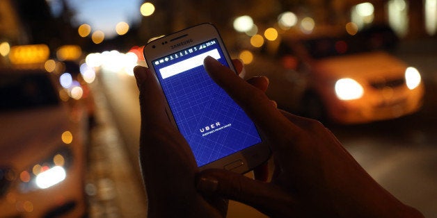 BERLIN, GERMANY - SEPTEMBER 02: In this photo illustration, a woman uses the Uber app on an Samsung smartphone on September