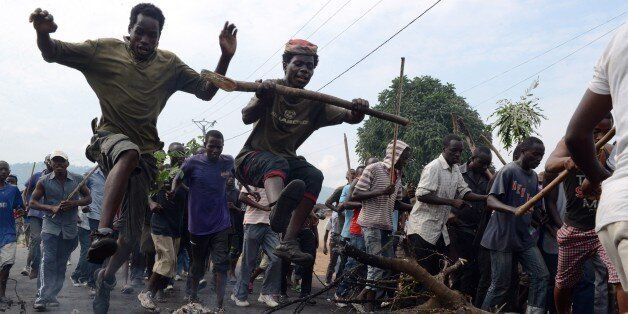 Burundian youth jump over a burning baricade as they demonstrate in Bujumbura, on May 1, 2015 against the president's bid for a third term. At least seven people have died and 66 others been wounded in nearly a week of clashes between police and protestors in the central African nation of Burundi, officials said on May 1. The unrest broke out after the ruling CNDD-FDD party designated President Pierre Nkurunziza as its candidate in the next presidential election, which is due to be held in the small central African nation on June 26. AFP PHOTO / SIMON MAINA (Photo credit should read SIMON MAINA/AFP/Getty Images)