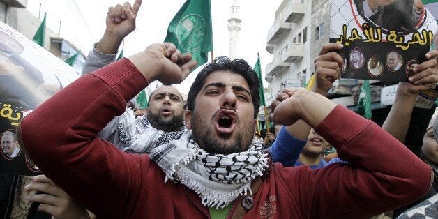 Supporters of the Muslim Brotherhood in Jordan shout slogans during a demonstration in the capital Amman on November 28, 2014