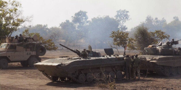 In this photo made available by the Nigerian Military taken Tuesday, April 28, 2015, Nigerian military personnel in action during an attack on Islamic extremists in the Sambisa Forest, Nigeria. Nigeria's military rescued 234 more girls and women from a Boko Haram forest stronghold in the country's northeast, an announcement on social media said Saturday, May 2, 2015. (Nigerian Military via AP)