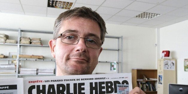 FILE - In this Sept.19, 2012 file photo, Stephane Charbonnier also known as Charb , the publishing director of the satyric we