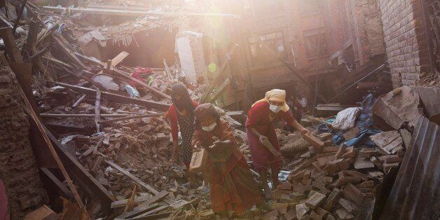 Nepalese woman remove debris searching their belongings from their house that was destroyed a week ago during the earthquake in Bhaktapur, Nepal, Sunday, May 3, 2015. The true extent of the damage from the April 25 earthquake is still unknown as reports keep filtering in from remote areas, some of which remain entirely cut off. The U.N. says the quake affected 8.1 million people â more than a quarter of Nepal's 28 million people. (AP Photo/Bernat Amangue)
