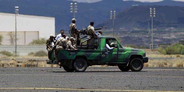 Shiite Huthi rebels ride a truck on May 5, 2015 as they inspect the damage done by air strikes of the Saudi-led coalition on the tarmac of the international airport of Sanaa, which is under their control. International relief agencies have voiced concern over Saudi-led coalition air strikes on airports in Yemen, warning they hamper aid delivery, as raids on rebel positions continued. AFP PHOTO / MOHAMMED HUWAIS (Photo credit should read MOHAMMED HUWAIS/AFP/Getty Images)