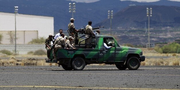 Shiite Huthi rebels ride a truck on May 5, 2015 as they inspect the damage done by air strikes of the Saudi-led coalition on