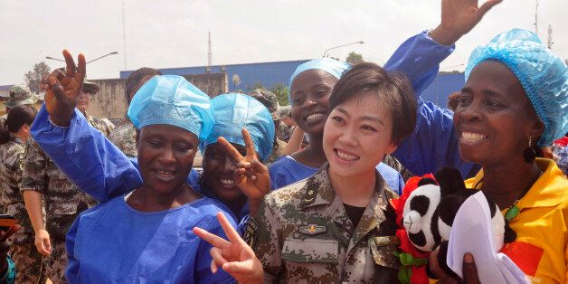 Ebola patient Beatrice Yardolo, right, celebrates with Ebola health workers as she leaves the Chinese Ebola treatment center were she was treated for Ebola virus infection on the outskirts of Monrovia, Liberia, Thursday, March 5, 2015. Liberia released its last Ebola patient, a 58-year old English teacher, from a treatment center in the capital on Thursday, beginning its countdown to being declared Ebola free. 'I am one of the happiest human beings today on earth because it was not easy going through this situation and coming out alive,' Beatrice Yardolo told The Associated Press after her release. She kept thanking God and the health workers at the center. (AP Photo/Abbas Dulleh)