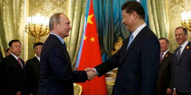 Russian President Vladimir Putin, left, shakes hands with his Chinese counterpart Xi Jinping during their meeting in Moscow's Kremlin, Russia, on Friday, May 8, 2015. (AP Photo/Alexander Zemlianichenko, pool)