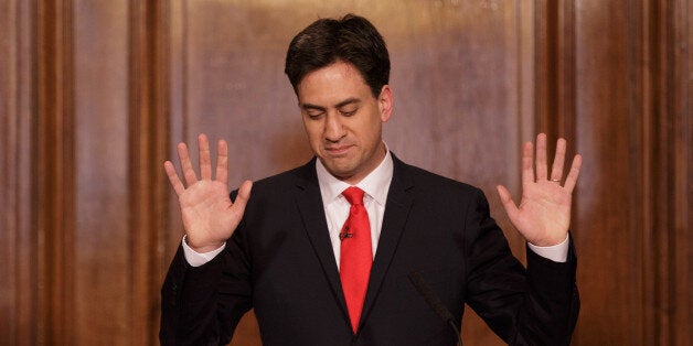 Britain's Labour Party leader Ed Miliband holds up his hands as he delivers his resignation at a press conference in Westminster, London, Friday, May 8, 2015. The Conservative Party surged to a seemingly commanding lead in Britain's parliamentary General Election, with Prime Minister David Cameron remaining in 10 Downing Street. (AP Photo/Tim Ireland)