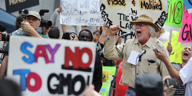 David King, founder and chairman of the Seed Library of Los Angeles, speaks to activists during a protest against agribusines