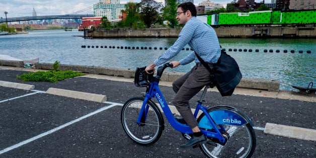 Alex Engel, with New York City Department of Transportation, rides a Bike Share bicycle during a demonstration of the program at the Brooklyn Navy Yards Sunday, May 12, 2013 in New York. The bike share system allows those who join to use ride bicycles and return them from the saw or different docks in part of New York. (AP Photo/Craig Ruttle)