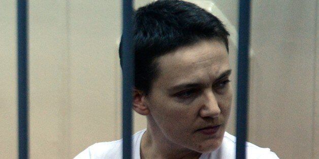 Detained Ukrainian helicopter pilot Nadiya Savchenko stands inside the defendant's cage during her hearing in the Basmanny district court in Moscow on November 11, 2014. Savchenko, a helicopter navigator in the Ukrainian airforce, was fighting in a Ukrainian volunteer battalion in eastern Ukraine while on leave from the armed forces. Russia alleges she was involved in the deaths of two Russian journalists who were killed by shelling close to a rebel checkpoint. It says she was arrested after crossing the border into Russia illegally. AFP PHOTO / VASILY MAXIMOV (Photo credit should read VASILY MAXIMOV/AFP/Getty Images)