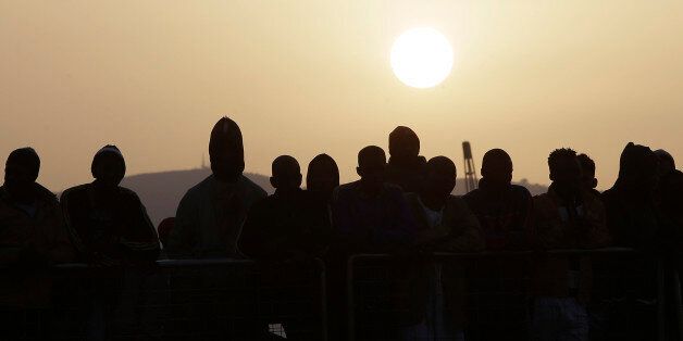 Migrants wait to disembark from the Iceland Coast Guard vessel Tyr, at the Messina harbor, Sicily, southern Italy, Wednesday, May 6, 2015. The weekend saw a dramatic increase in rescues as smugglers in Libya took advantage of calm seas and warm weather to send thousands of would-be refugees out into the Mediterranean in overloaded rubber boats and fishing vessels. The coast guard reported that nearly 7,000 people were rescued in the three days ending Sunday. (AP Photo/Antonio Calanni)