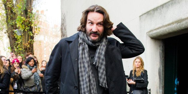 Author, journalist and director Frederic Beigbeder arrives to attend the Dior men's Fall-Winter 2014-2015 fashion collection, presented Saturday, Jan. 18, 2014 in Paris. (AP Photo/Zacharie Scheurer)