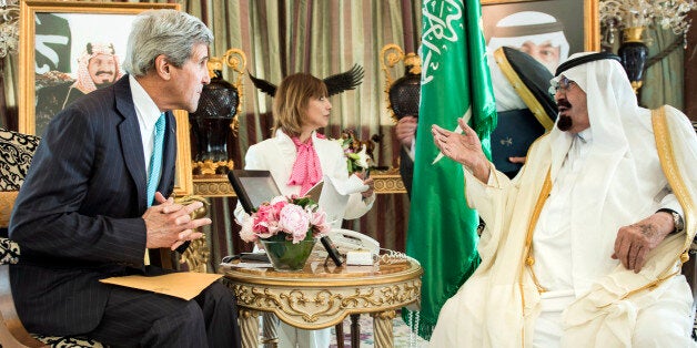 US Secretary of State John Kerry listens as King Abdullah speaks before meeting at the King's private residence Friday, June 27, 2014 in Jeddah, Saudi Arabia. Kerry signaled on Friday that the U.S. hopes to enlist moderate Syrian opposition fighters that the Obama administration has reluctantly decided to arm and train in the battle against militant extremists in neighboring Iraq. (AP Photo/Brendan Smialowski, Pool)