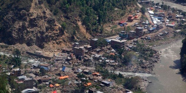 Damaged houses are seen from a helicopter at Charikot, Nepal, Thursday, May 14, 2015. Nepal has been overwhelmed by its second massive earthquake in less than three weeks, its prime minister said Thursday as he visited this normally placid foothills town, now a center for frightened villagers desperate for government help. (AP Photo/Niranjan Shrestha)