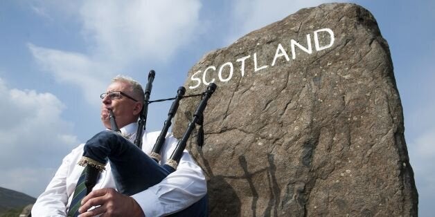 Piper Allan Smith plays the bagpipes for visitors near the town of Selkirk on the border between England and Scotland on Sept