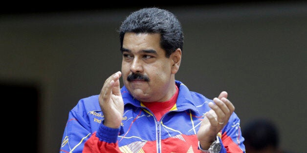 Venezuela's President Nicolas Maduro applauds during the closing of the "Cumbre de los Pueblos" or "People's Summit" in Panama City, Saturday, April 11, 2015. (AP Photo/Arnulfo Franco)