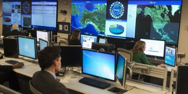 Staff members sit at their work stations at the National Cybersecurity and Communications Integration Center in Arlington, Virginia, January 13, 2015. US President Barack Obama visited the facility to talk about cyber security. AFP PHOTO / SAUL LOEB (Photo credit should read SAUL LOEB/AFP/Getty Images)