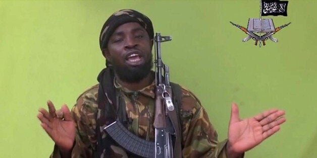 FILE -This May 12, 2014, file photo taken from video by Nigeria's Boko Haram terrorist network, shows their leader Abubakar Shekau speaking to the camera. Islamic State militants have accepted a pledge of allegiance by the Nigerian-grown Boko Haram extremist group, a spokesman for the Islamic State movement said Thursday, March 12, 2015. On Saturday, Shekau posted an audio recording online that pledged allegiance to IS. On Thursday, the Islamic State group's media arm Al-Furqan, in an audio recording by spokesman Abu Mohammed al-Adnani, said that Boko Haram's pledge of allegiance has been accepted, claiming the caliphate has now expanded to West Africa. (AP Photo/File)