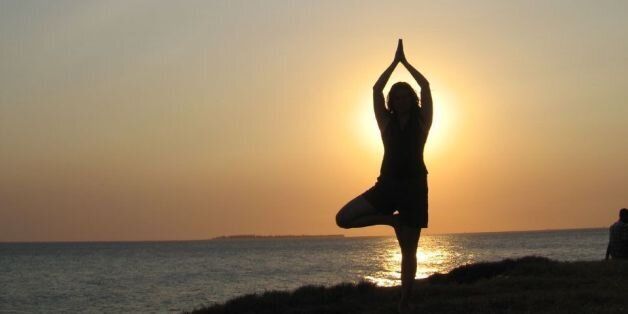Janette does yoga at sunset, Stone Town, Zanzibar, Indian Ocean.