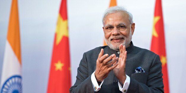India's Prime Minister Narendra Modi applauds as he attends the opening ceremony for the Centre for Gandhian and Indian Studies at Fudan University in Shanghai on May 16, 2015. Modi is on a three-day visit to China. AFP PHOTO / JOHANNES EISELE (Photo credit should read JOHANNES EISELE/AFP/Getty Images)
