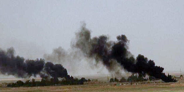 This picture released on Wednesday, May 20, 2015 on the website of Islamic State militants, shows black columns of smoke rising through the air during a battle between Islamic State militants and the Syrian government forces on a road between Homs and Palmyra, Syria. Islamic State militants overran the famed archaeological site at Palmyra early on Thursday, just hours after seizing the central Syrian town, activists and officials said, raising concerns the extremists might destroy some of the priceless ruins as they have done in neighboring Iraq. (The website of Islamic State militants via AP)