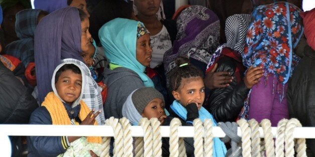 Migrants wait to disembark from Migrant Offshore Aid Station (MOAS) ship in the port of Messina, on May 16, 2015 following rescue operations at sea off the coast of Sicily in partnership with NGO Doctors Without Borders. AFP PHOTO / GIOVANNI ISOLINO (Photo credit should read GIOVANNI ISOLINO/AFP/Getty Images)