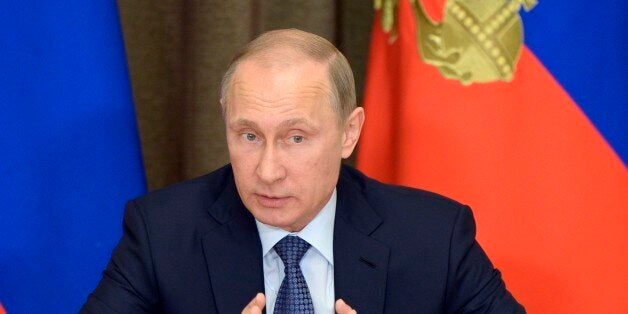 Russian President Vladimir Putin speaks at a meeting with representatives of top military brass and defense industries at the