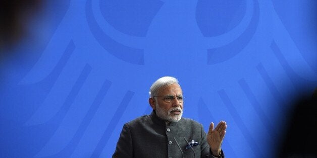 Indian Prime Minister Narendra Modi gestures during a press conference after talks with the German Chancellor in Berlin on Ap