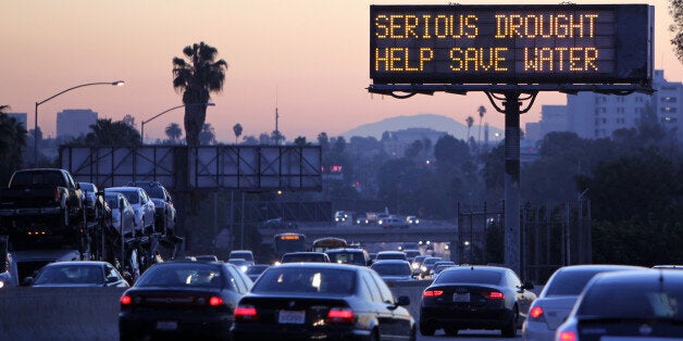 Morning traffic makes it's way toward downtown Los Angeles along the Hollywood Freeway past an electronic sign warning of severe drought on Friday, Feb. 14, 2014. California is taking to the highways to spread the word about water conservation after months of drought. This week the California Department of Transportation launched an education campaign with 700 electronic highway boards displaying the message: "Serious Drought. Help Save Water." (AP Photo/Richard Vogel)