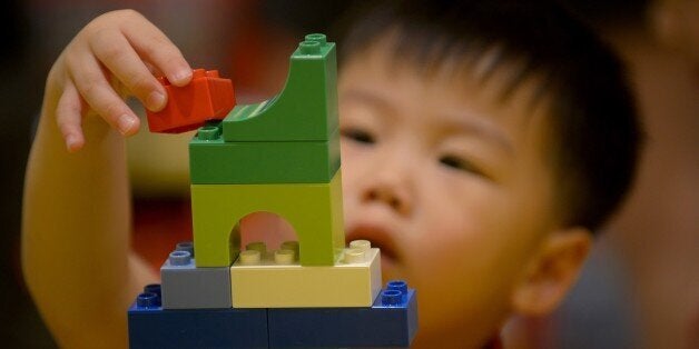 A child plays with Lego blocks during the opening of the brand's first certified store in Manila on May 12, 2015. Lego, the w