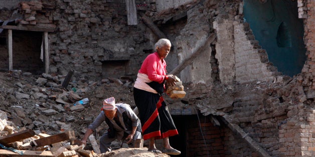 Kanchan Khyamali, 73, and his wife Krishna Kumari Khyamali collect bricks from damaged buildings in Bhaktapur, Nepal, Thursda