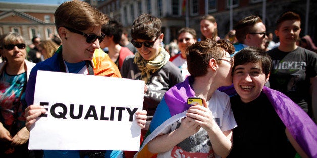 Yes supporters celebrate as first results begin to filter through in referendum at Dublin castle, Ireland, Saturday, May 23, 2015. Ireland has voted resoundingly to legalize gay marriage in the world's first national vote on the issue, leaders on both sides of the Irish referendum declared Saturday even as official ballot counting continued. Senior figures from the "no" campaign, who sought to prevent Ireland's constitution from being amended to permit same-sex marriages, say the only question is how large the "yes" side's margin of victory will be from Friday's vote. (AP Photo/Peter Morrison)