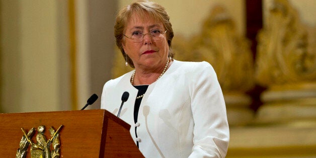 FILE - In this Friday, Jan. 30, 2015, file photo, Chile's President Michelle Bachelet listens to Guatemala's President Otto Perez Molina during their joint press conference at the National Palace in Guatemala City. President Bachelet has asked on Wednesday, May 6, 2015, for all her Cabinet ministers to submit their resignations. (AP Photo/Moises Castillo, File)