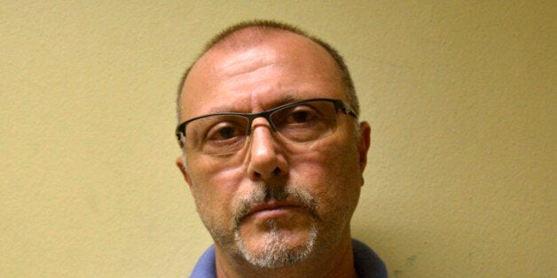 This photo released by Brazil's Federal Police shows Italian Pasquale Scotti, after his arrest in Recife, Brazil, Tuesday, May 26, 2015. A Federal Police statement says Scotti, a suspected boss of the Camorra, the Naples-based organized crime syndicate, was arrested Tuesday morning after almost 30 years on the run, in the northeastern city of Recife. (Brazil Federal Police via AP)