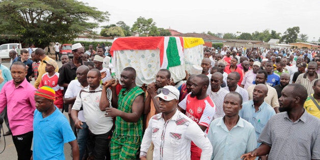 Men carry the coffin of UPD-Zigamibanga party Zedi Feruzi, during his funeral, in Bujumbura, Burundi, Sunday, May 24, 2015. Opposition leader Zedi Feruzi of the UPD-Zigamibanga party was slain late Saturday in a drive-by shooting in which one of his bodyguards was also killed, and a journalist wounded. (AP Photo/Gildas Ngingo)