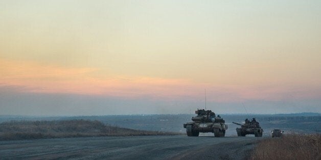 Tanks of pro-Russian separatists ride on the road from Donetsk to Novoazovsk, Mariupol district on February 24, 2015. Foreign ministers from Ukraine, Russia, Germany and France called Tuesday for a total ceasefire in eastern Ukraine as Russian President Vladimir Putin ruled out the 'apocalyptic scenario' of all-out war. AFP PHOTO/ ANDREY BORODULIN (Photo credit should read ANDREY BORODULIN/AFP/Getty Images)