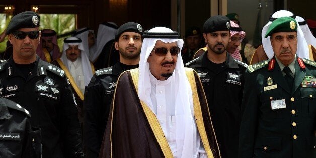 Saudi King Salman bin Abdulaziz (C) walks surrounded by security officers to receive Bahraini King Hamad bin Isa al-Khalifa (unseen) upon the latter's arrival in Riyadh to attend the Gulf Cooperation Council (GCC) summit on May 5, 2015. AFP PHOTO / FAYEZ NURELDINE (Photo credit should read FAYEZ NURELDINE/AFP/Getty Images)