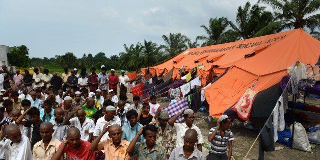 Rohingya men from Myanmar perform congregational Friday prayers at the newly set up confinement area for migrants at Bayeun, Aceh province on May 22, 2015 after more than 400 Rohingya migrants from Myanmar and Bangladesh were rescued by Indonesian fishermen off the waters of the province on May 20. The widespread persecution of the impoverished community in Myanmar's Rakhine state is one of the primary causes for the current regional exodus, alongside growing numbers trying to escape poverty in neighbouring Bangladesh. AFP PHOTO / ROMEO GACAD (Photo credit should read ROMEO GACAD/AFP/Getty Images)