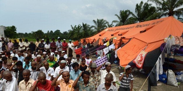 Rohingya men from Myanmar perform congregational Friday prayers at the newly set up confinement area for migrants at Bayeun,