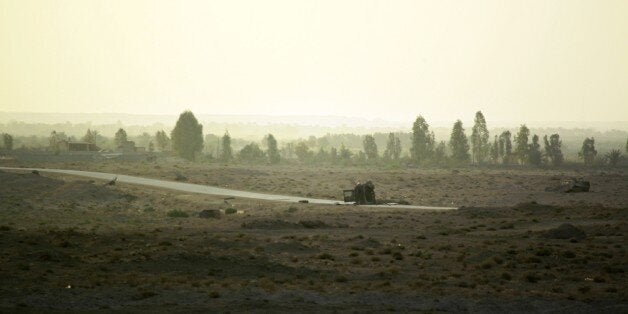 Carcass of vehicles are seen in Amriyat al-Fallujah, in Iraq's Anbar province, where Iraqi Sunni men presented as former jiha