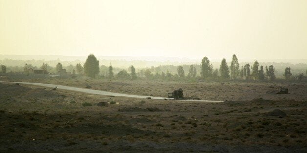 Carcass of vehicles are seen in Amriyat al-Fallujah, in Iraq's Anbar province, where Iraqi Sunni men presented as former jihadists fighting alongside the Islamic State (IS) group who defected to join Iraq government forces, are deployed, on May 26, 2015. Iraqi forces took up positions on the southern outskirts of Ramadi, officials said, taking two neighbourhoods and moving into Anbar university. Army and police forces as well as allied paramilitaries clashed with IS fighters to take full control of Taesh and Humeyrah, an army colonel said. AFP PHOTO / HAIDAR HAMDANI (Photo credit should read HAIDAR HAMDANI/AFP/Getty Images)