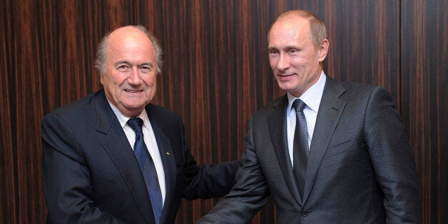 FILE - Russian Prime Minister Vladimir Putin, right, shakes hands with FIFA President Joseph Blatter after Russia was announc