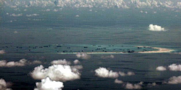 This areal photo taken through a glass window of a military plane shows China's alleged on-going reclamation of Mischief Reef in the Spratly Islands in the South China Sea Monday, May 11, 2015. Gen. Gregorio Pio Catapang, the Philippines' military chief, has flown to Pag-asa Island, a Filipino-occupied island in the South China Sea amid territorial disputes in the area with China, vowing to defend the islet and help the mayor develop tourism and marine resources there. (Ritchie B. Tongo/Pool Photo via AP)