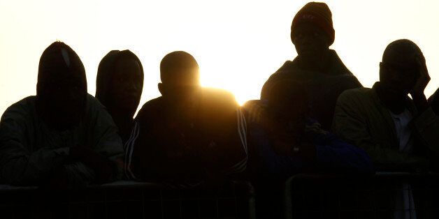 Migrants wait to disembark from the Iceland Coast Guard vessel Tyr, at the Messina harbor, Sicily, southern Italy, Wednesday, May 6, 2015. This weekend saw a dramatic increase in rescues as smugglers in Libya took advantage of calm seas and warm weather to send thousands of would-be refugees out into the Mediterranean in overloaded rubber boats and fishing vessels. (AP Photo/Antonio Calanni)