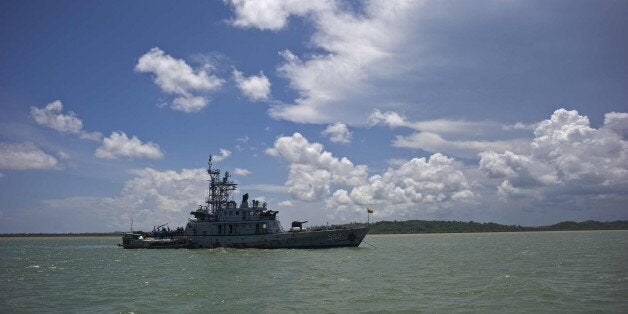 A Myanmar navy ship is anchored near Haigyi island, NgaPuTaw Township, Irrawaddy Division on May 30, 2015. More than 700 migr