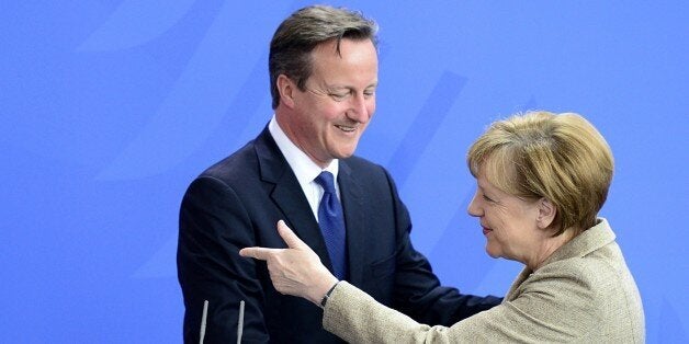 German Chancellor Angela Merkel (R) and British Prime Minister David Cameron shake hands at the end of their joint statement