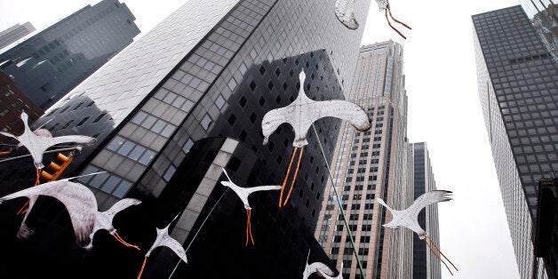 Bird-shaped kites are held in the air as demonstrators make their way down Sixth Avenue during the People's Climate March Sun