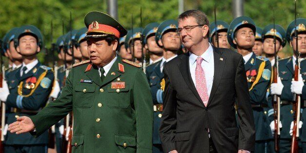 US Secretary of Defense Ashton Carter (R) and Vietnam's Defence Minister Gen. Phung Quang Thanh (front L) review an honour guard during a welcoming ceremony at the Ministry of Defense in Hanoi on June 1, 2015. Carter on an Asian trip to Singapore, Vietnam and India in his second tour of the region since taking over at the Pentagon in February. AFP PHOTO / POOL / HOANG DINH Nam (Photo credit should read HOANG DINH NAM/AFP/Getty Images)