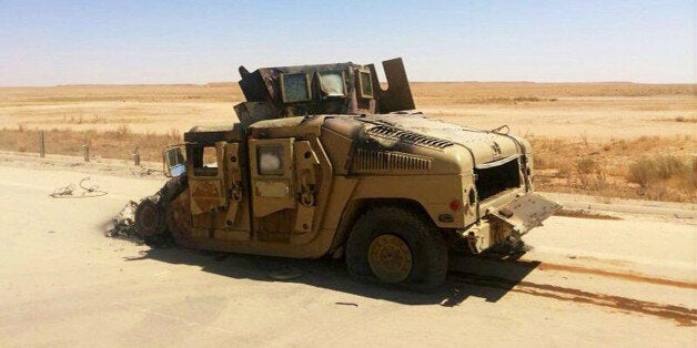 A destroyed Iraqi army humvee is left behind outside of the northern city of Mosul, Iraq, Wednesday, June 25, 2014, more than